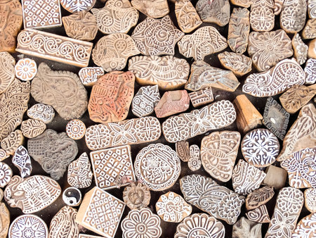 Jaisalmer, India - Circa March, 2018. Wooden stamps printing blocks hand carved by artisans on the street market in Jaisalmer, India. Henna stamps for decorating the body or clothes.のeditorial素材