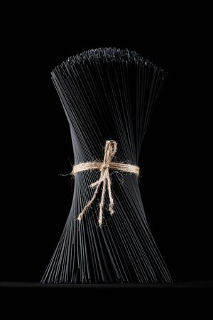 Black spaghetti pasta on a black background.の写真素材