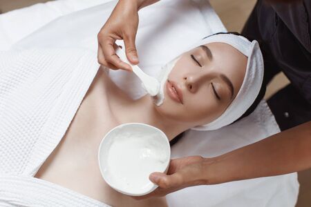 Facial Mask. Woman Applying Cosmetic Alginate Maskの写真素材