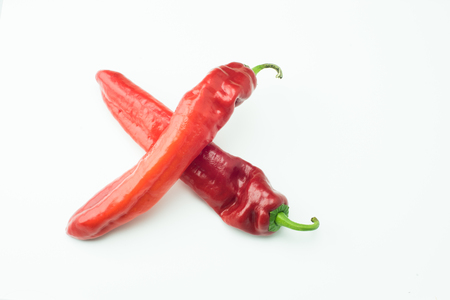 fresh sweet red peppers paprika isolated on white backgroundの写真素材