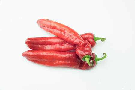 fresh sweet red peppers paprika isolated on white backgroundの写真素材