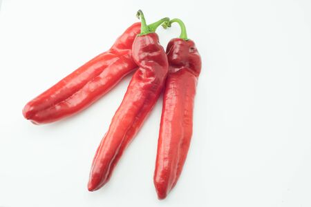 fresh sweet red peppers paprika isolated on white backgroundの写真素材