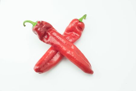 fresh sweet red peppers paprika isolated on white backgroundの写真素材