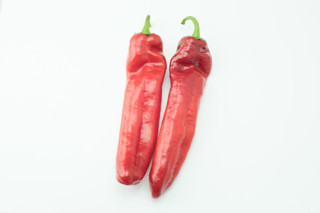 fresh sweet red peppers paprika isolated on white backgroundの写真素材