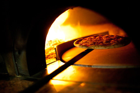 A pizza in a oven burningの写真素材