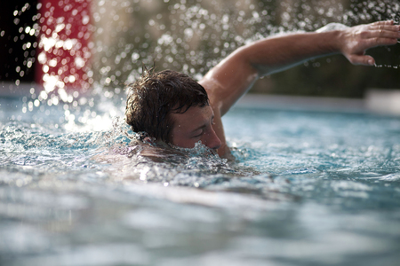 Young handsome Man Swimming In the Poolの写真素材