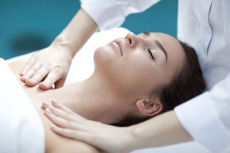 Young woman getting a massage in a spaの写真素材