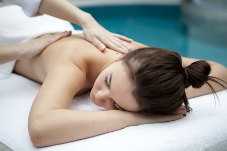 Young woman getting a massage in a spaの写真素材