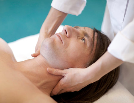 Handsome man laying on a massage bed
