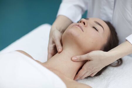 Young woman getting a massage in a spaの写真素材