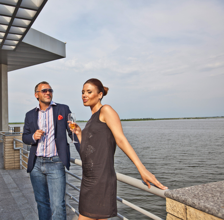 Young couple with champagne glasses in restaurantの写真素材