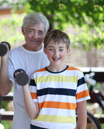 Grandfather and grandson of exercising with dumbbellsの写真素材
