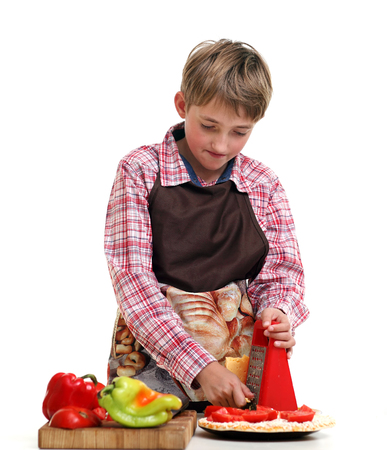 Boy rub vegetables in the white backgroundの写真素材
