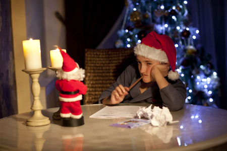 Boy writes a letter to Santa Clausの写真素材