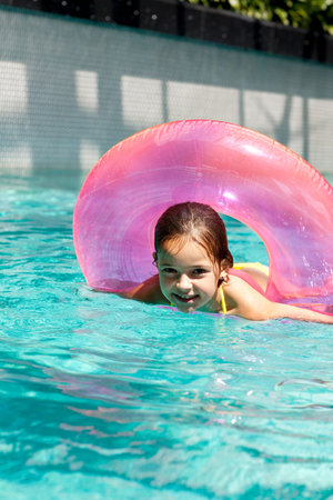 girl child in blue water of the swimming pool