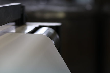 Spools of paper .Working print machine. selective focus on metal shafts and screwsの写真素材