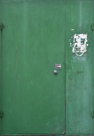 The old double-floor iron door is green and vintage-likeの写真素材