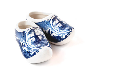 Blue and white porcelain shoes on a white background. Isolated object.