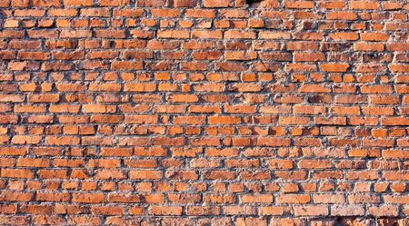 Texture of a brick wall. Grunge brick texture for designers. Red brick rough masonry.の写真素材