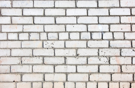 Texture of a white brick wall. Grunge brick texture for designers. White brick rough masonry.