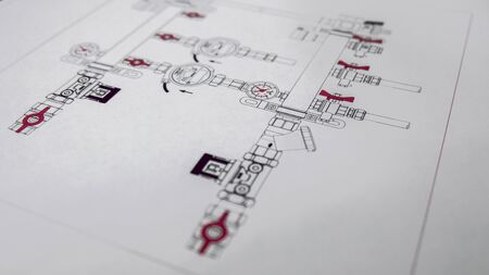 Engineering design of heating and water supply. Selective focus. Engineering drawing on white paper. Drawing of pipes and shut-off valves. The concept of the project design.の写真素材