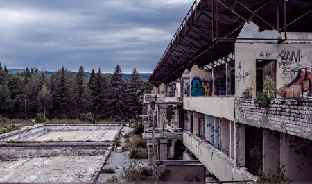 Abandoned destroyed building against the background of the forest. Abandonment on light background....