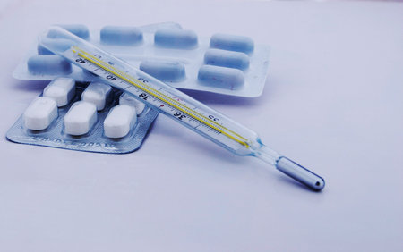 foto of tablet and clinical thermometer on white backgroundの写真素材