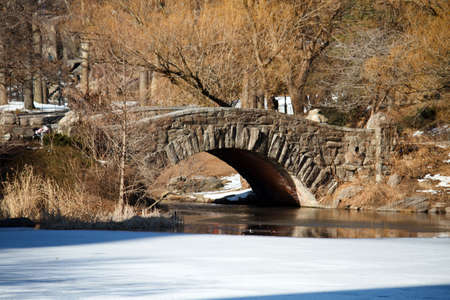 A foot bridge over an iced lake during winterの写真素材