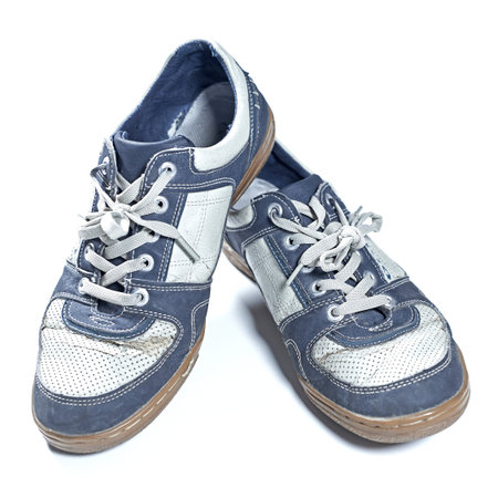 Old worn out sneakers isolated on white