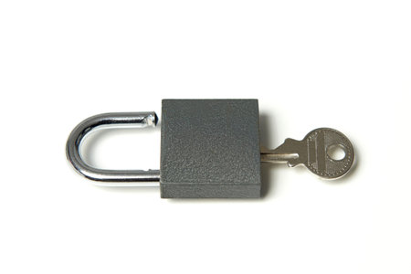 Padlock with key in it on a white background