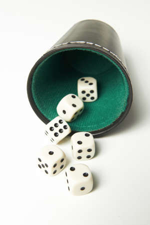 Rolling the dices on a white backgroundの写真素材