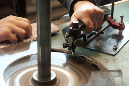 Closeup image of hands of a person cutting a diamond