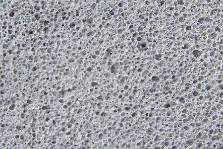 Closeup image of a grey sponge with texture detailsの写真素材