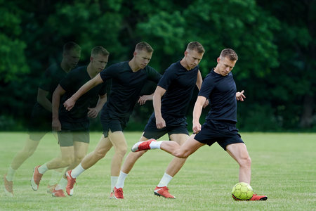 Football player kicking a yellow ball in high speed and with power in multiple exposures