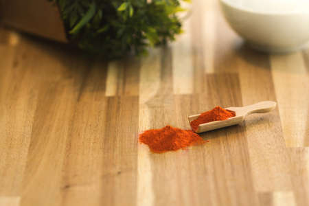 Chili spice powder and herbs on a wooden spoon. Ingredients for cooking and seasoning.の写真素材