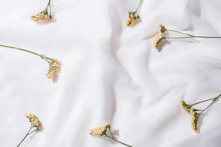 Top view of voile fabric background with flowers with space for textの写真素材