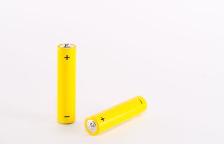 Two yellow AAA alkaline batteriesの写真素材