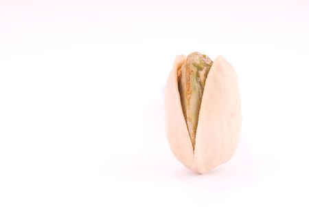 Macro of a pistachio on white の写真素材