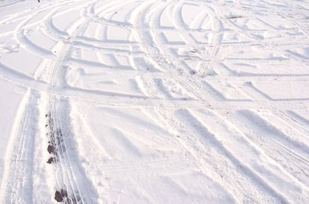 Car tire track in fresh light snowの写真素材