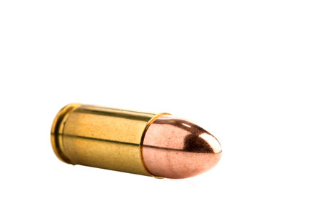 Shiny 9 mm pistol cartridge isolatedの写真素材