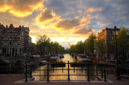 Canal in Amsterdam at sunset in summer hdrの写真素材