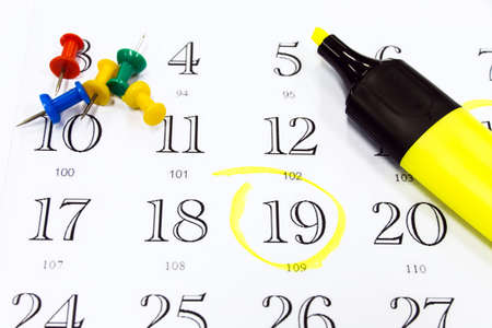 Push pins and marker on a calendarの写真素材