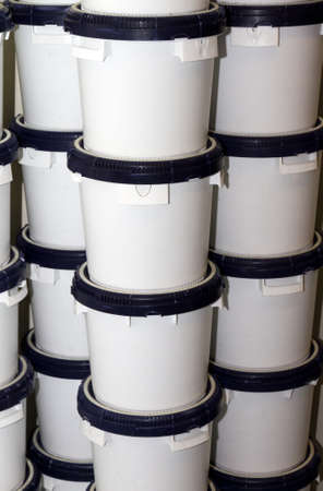 Stacked white buckets with blue litsの写真素材