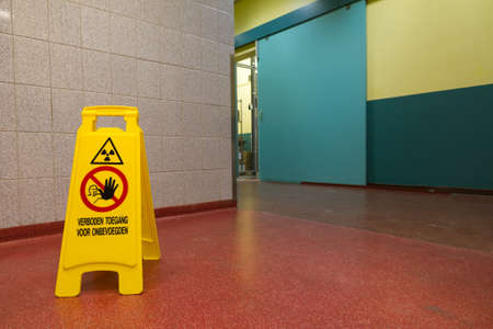 A sign warning for radioactivity on the ground in a hallwayの写真素材