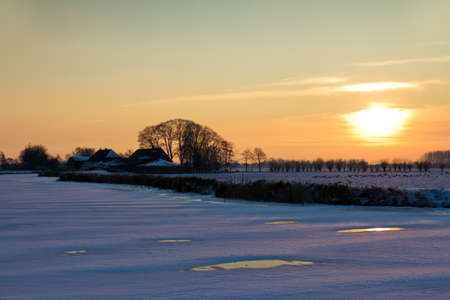 Dutch landscape sunset on a icy winter dayの写真素材