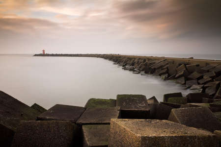 Concrete blocks form the jetty of the harbor of Scheveningen in the Netherlandsのeditorial素材