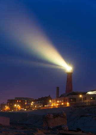 Ray s of light shining from the lighthouse in Scheveningen, the Netherlands, at sunsetのeditorial素材