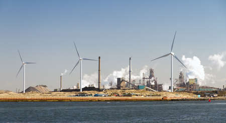 Heavy industry and wind turbines in the harbor of Ijmuiden, The Netherlandsの写真素材
