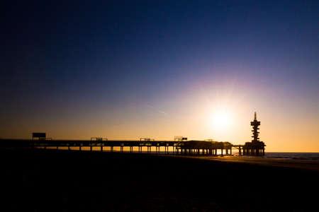 Evening silhouette of the pier of Scheveningen, the Netherlands の写真素材