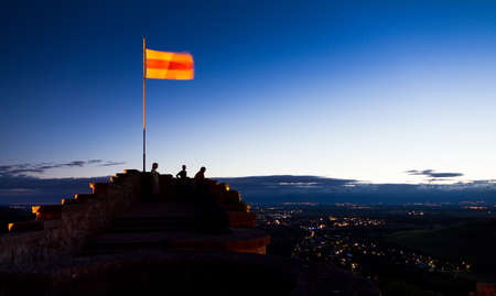 People looking out over the valley in the area of Badenweiler with the local flag waving in the windの写真素材